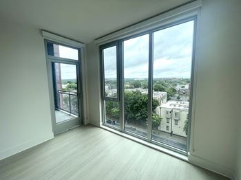 A living room with large windows and a view of the city